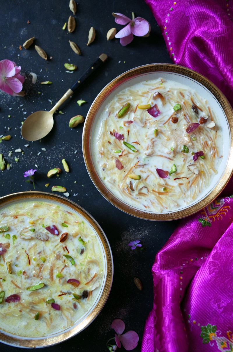 Two bowls of Seviyan Kheer topped with rose and pistachios