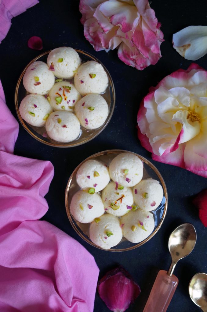 14 Bengali Rasgulla with a Rose and Cardamon Syrup on a dark background with roses