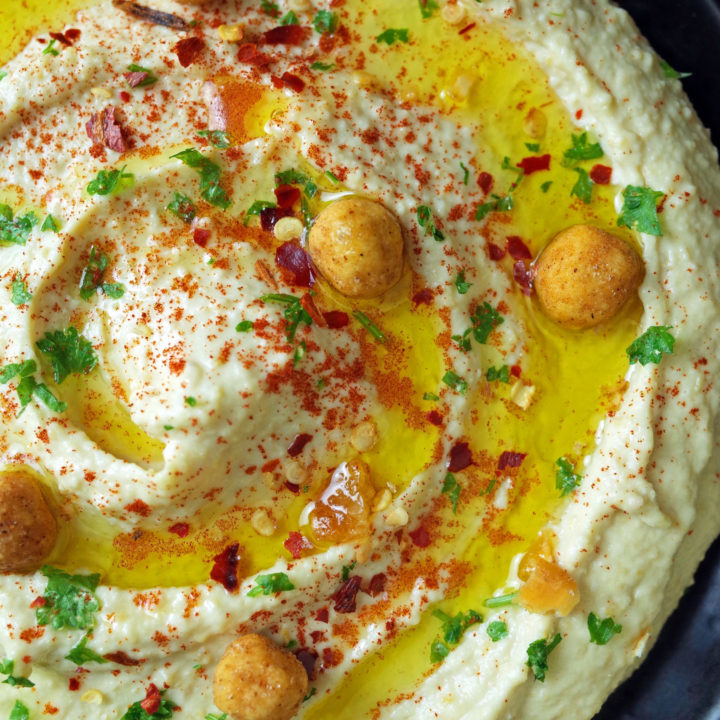 Smooth and Creamy Plain Hummus topped with olive oil, parsley, paprika, chilli and roasted chickpeas