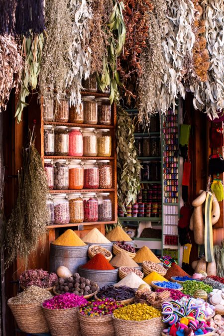 A spice market with various different spices in baskets and jars