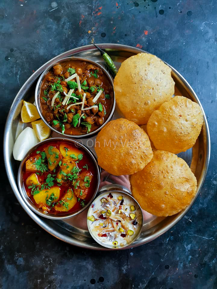 Indian Thali with Chana Masala, Batata Rassa, Seviyan Kheer and Puris