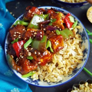 Sweet sticky & spicy Vegan Chilli Tofu with Egg Fried Rice in a blue bowl
