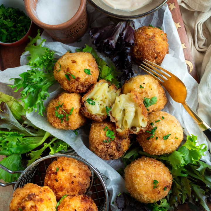 Mac and cheese bites on a plate with mayonnaise and salad