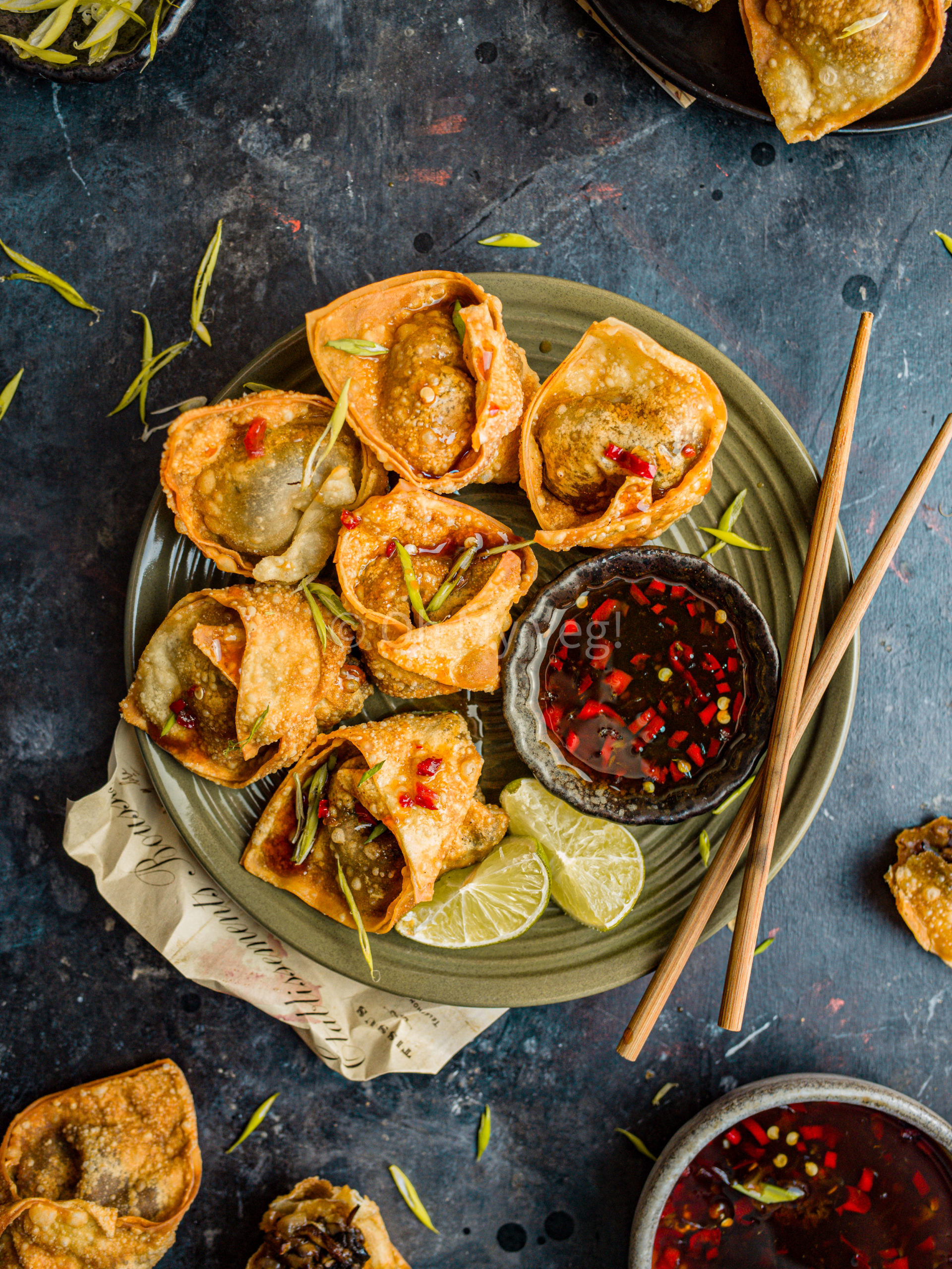 Fried vegan mushroom wontons with lime and sweet chili sauce on a plate