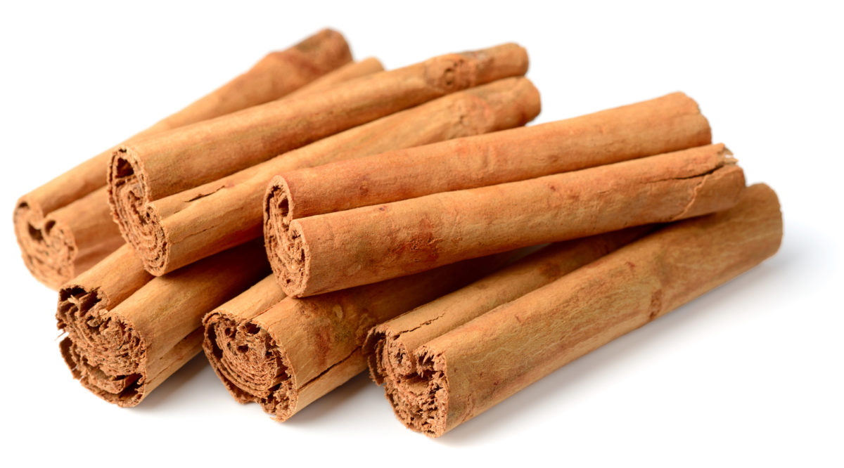 Five sticks of true cinnamon on a white background. 