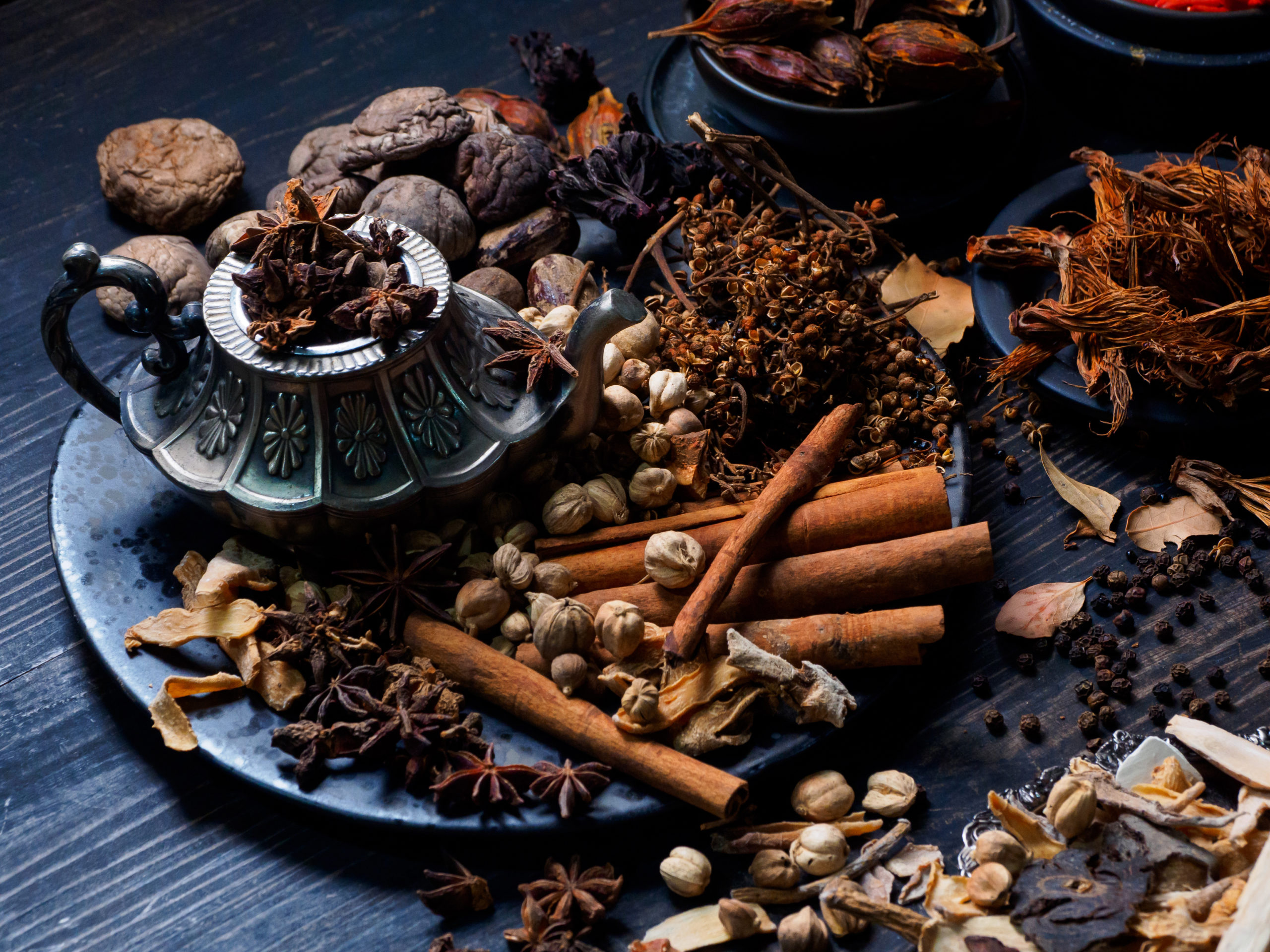 A plate featuring essential spices for cooking Indian garam masala, including cinnamon, star anise, cloves, and more. 