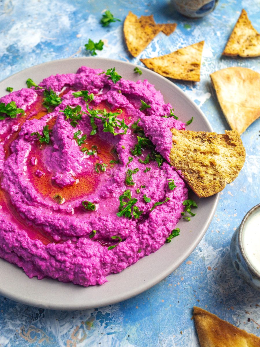 A bowl of pink beetroot hummus. 