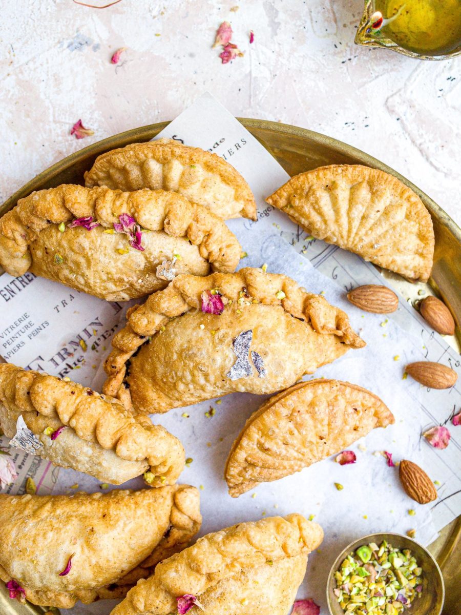 Gujiya with coconut on gold plate