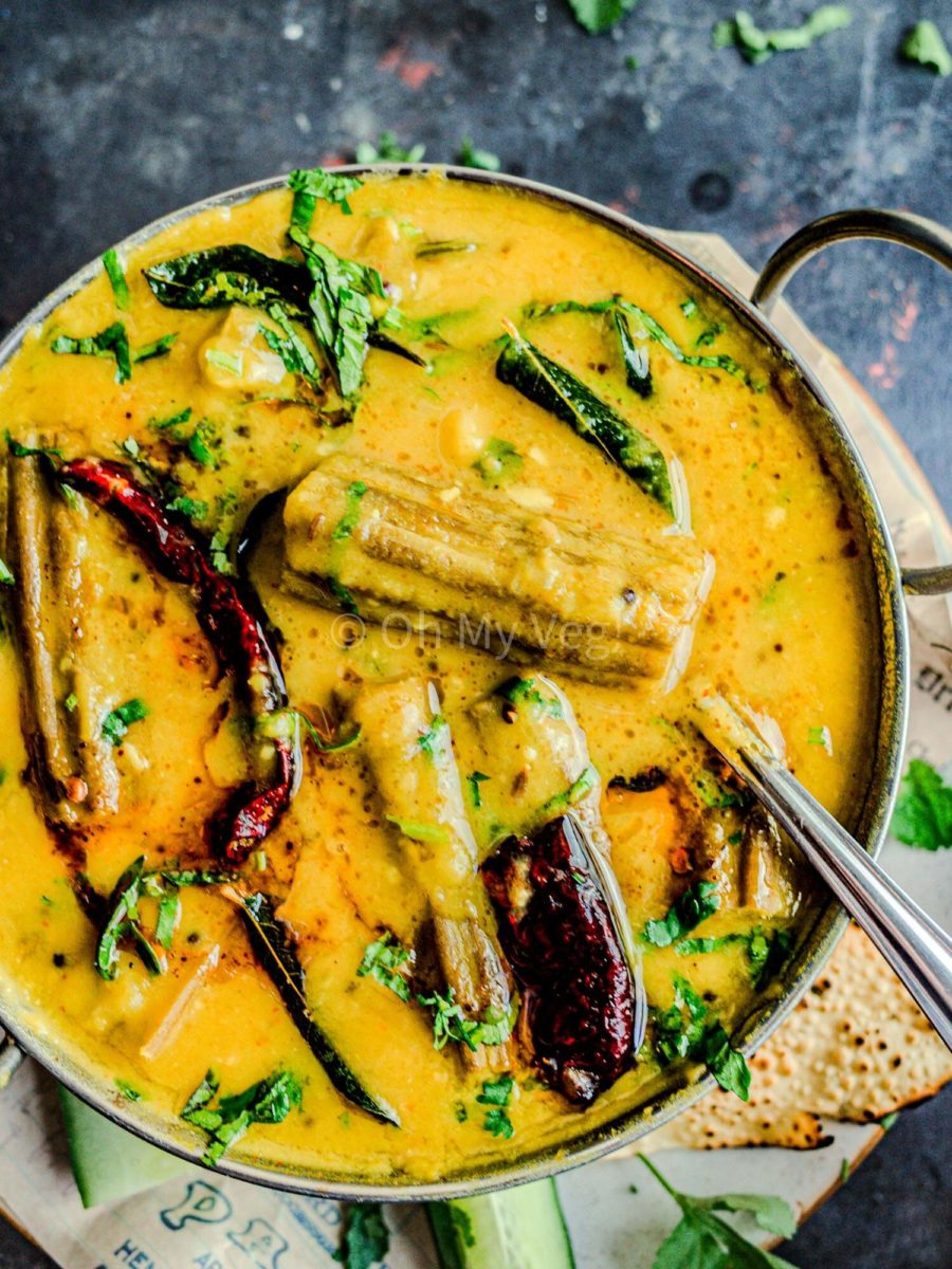 Shevgyachya shenganchi amti in a kadai with spoon.