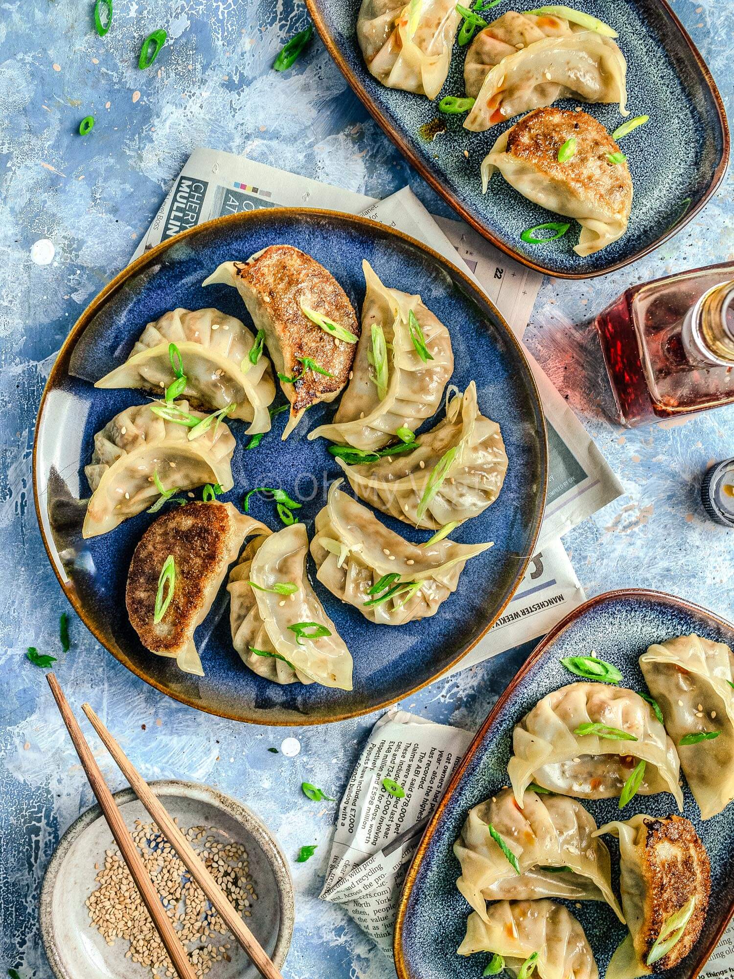 Vegetable gyoza on blue plates.