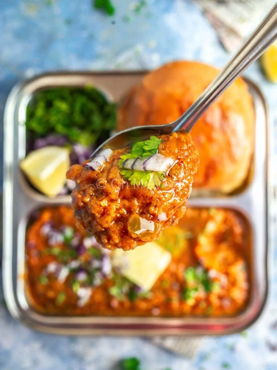 A spoon with Indian curry on it. 