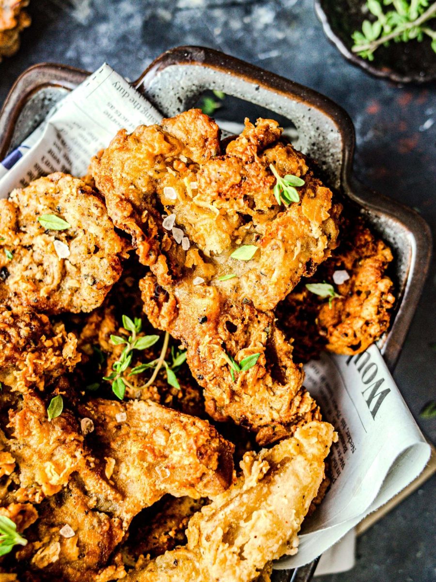 Crispy vegan fried chicken pieces topped with thyme.