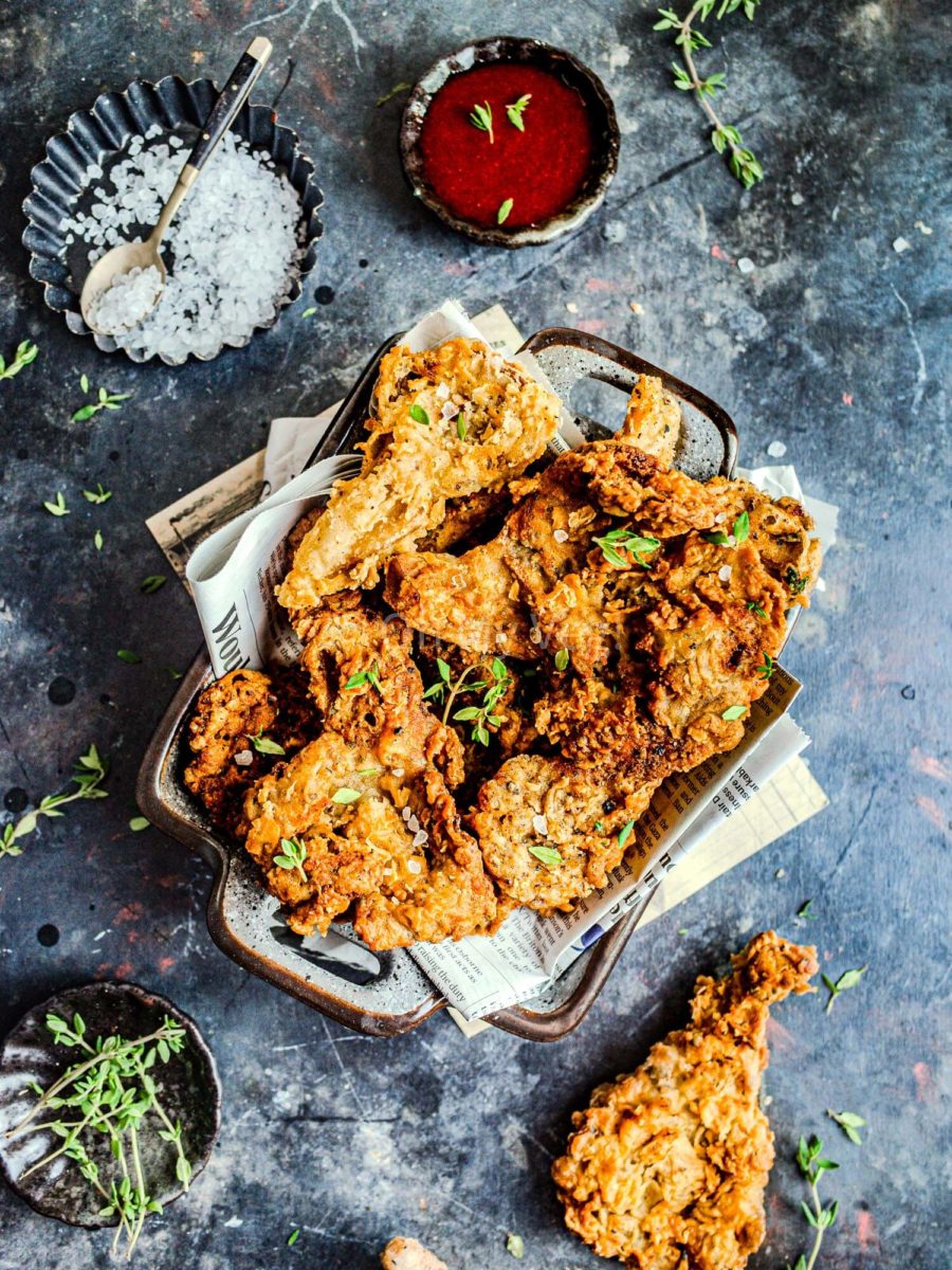 Vegan fried chicken made from mushrooms, on newspaper. 