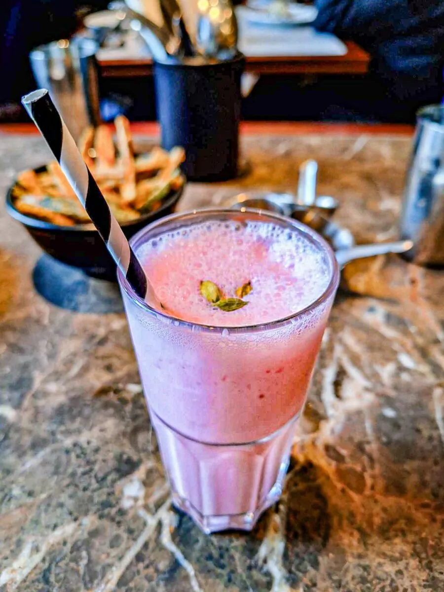 Rose and cardamon lassi in a glass at Dishoom Manchester. 