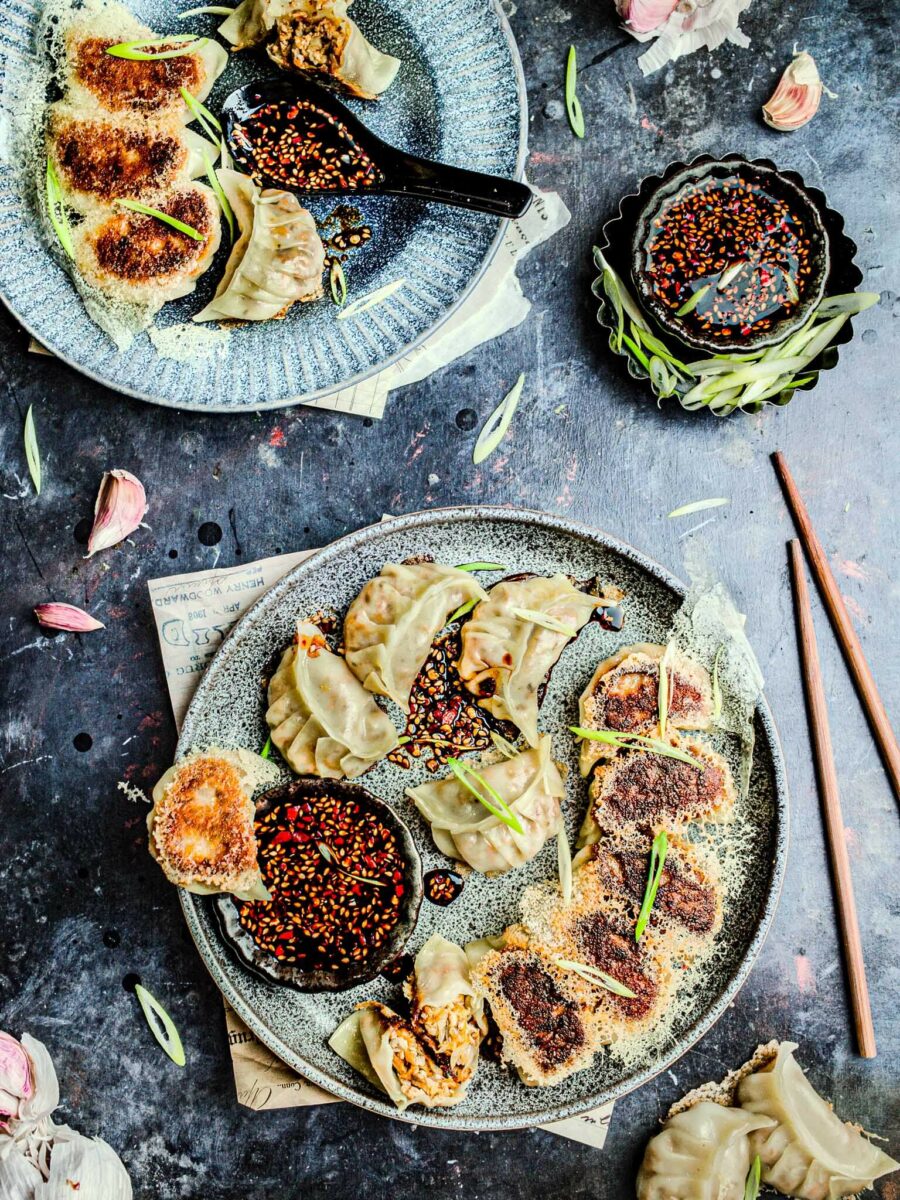 Tofu potstickers on a plate with sauce.