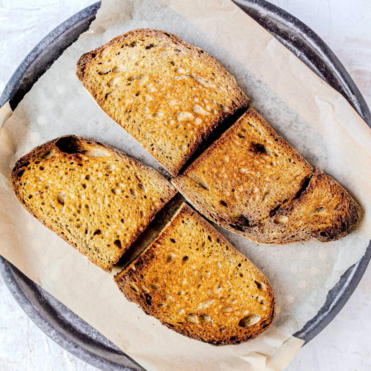 Toasted bread on a baking tray.