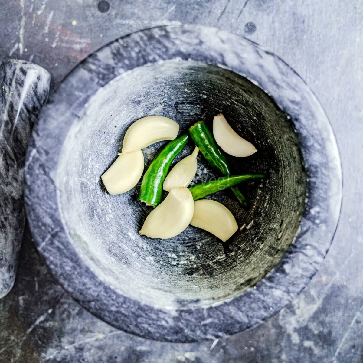 Garlic and chilli in mortar and pestle.