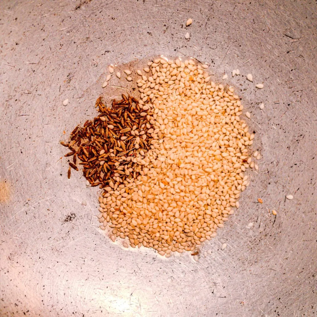 Sesame seeds and cumin in oil.