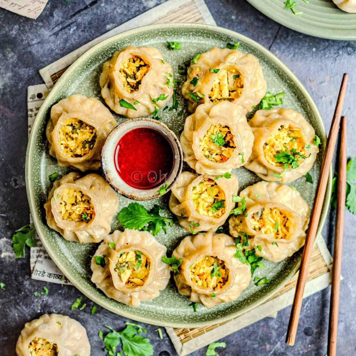 Paneer momos on a plate with chutney.