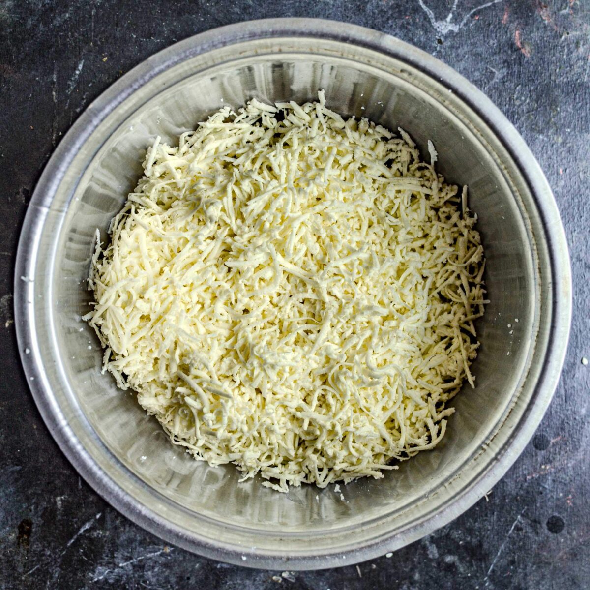 Paneer grated in bowl.