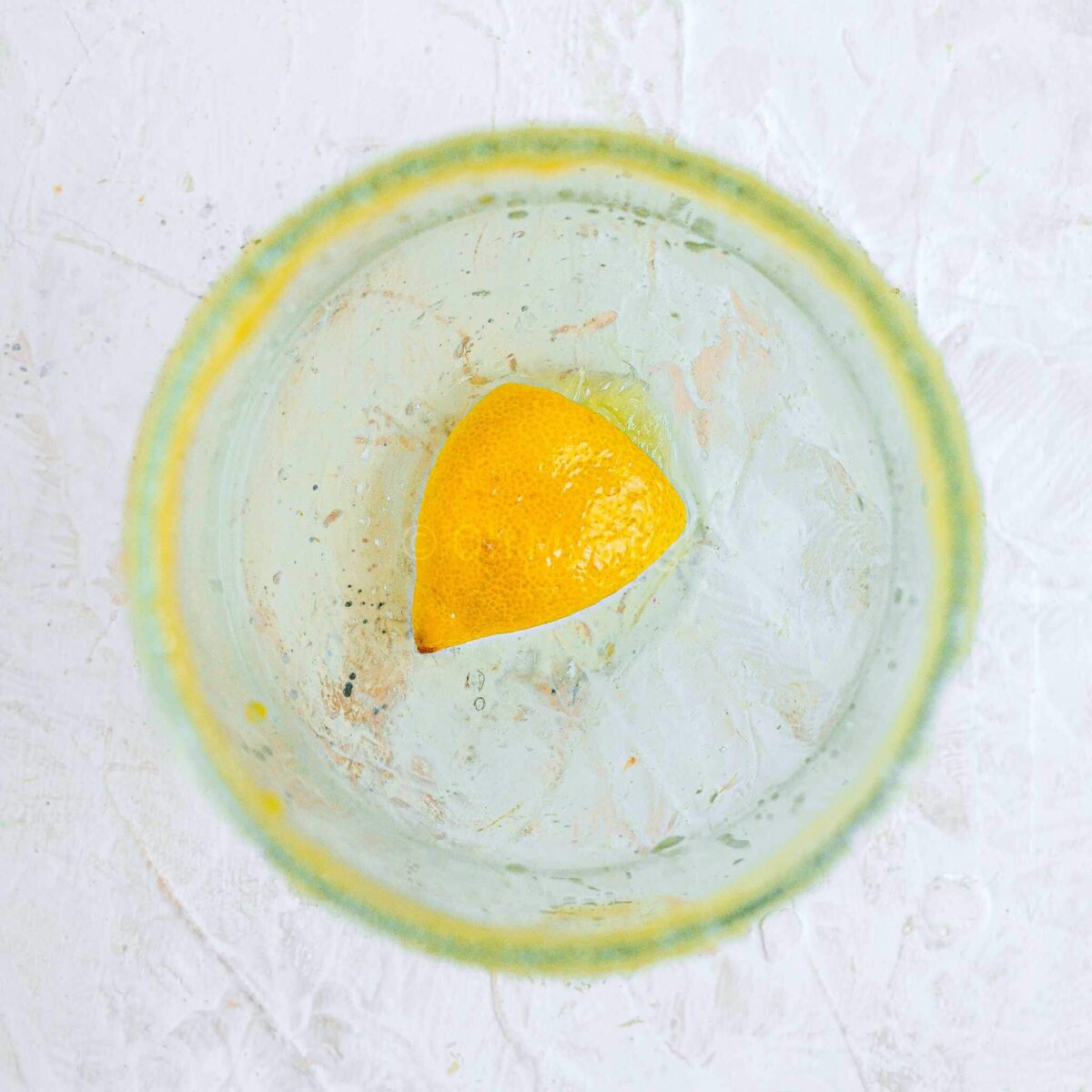 Muddled lemon in a glass.