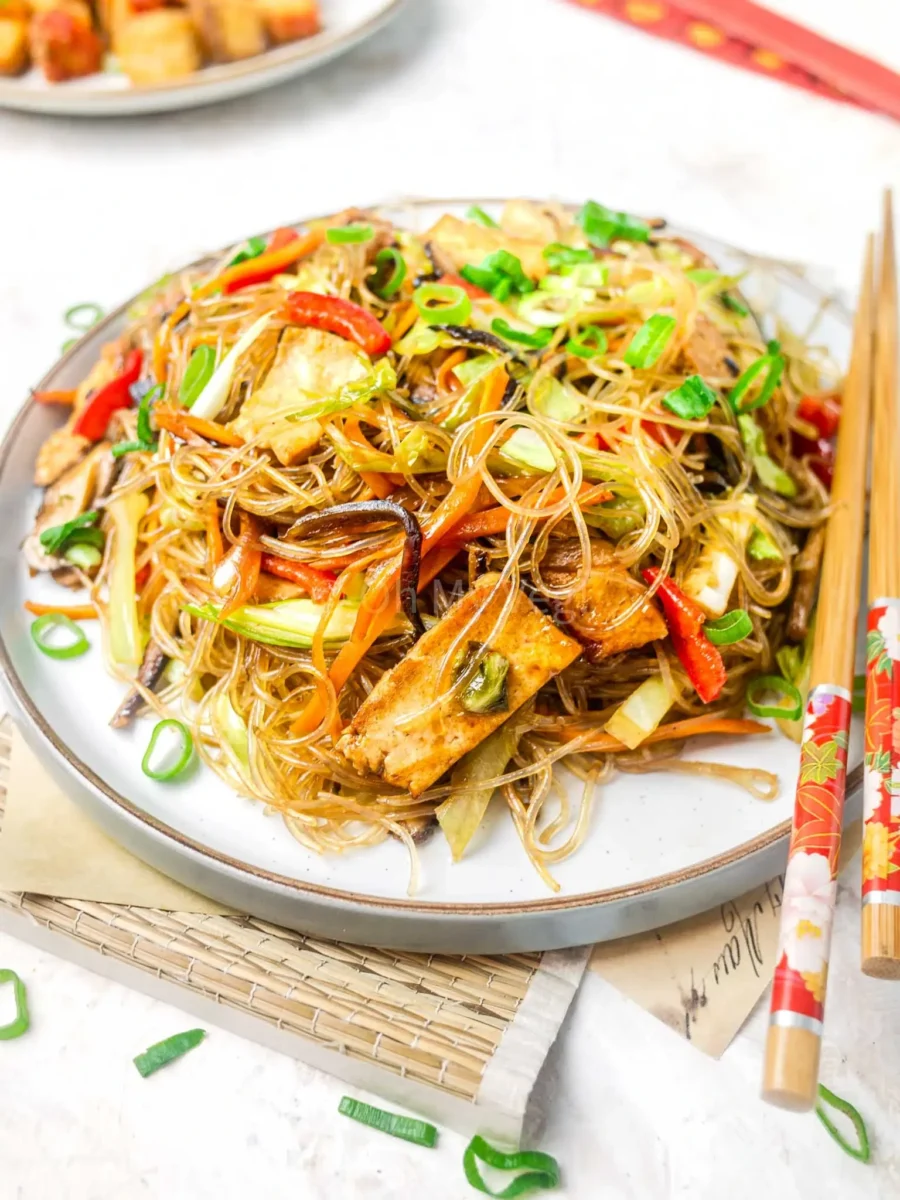 Stir-fried glass noodles on plate.