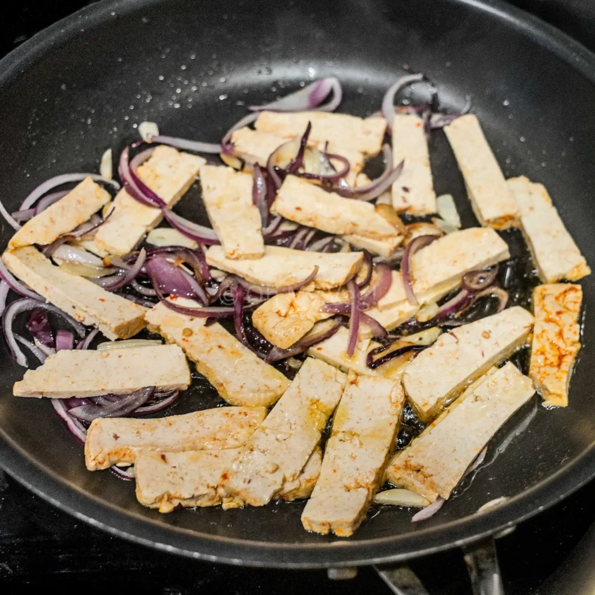 Stir-frying tofu.