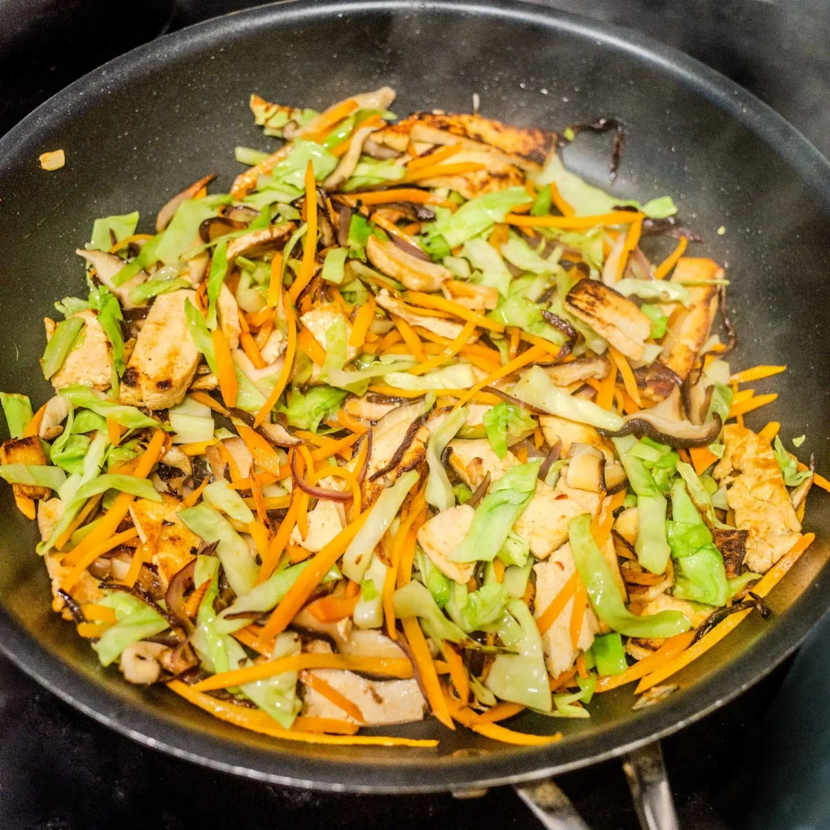 Cabbage added to the pan.