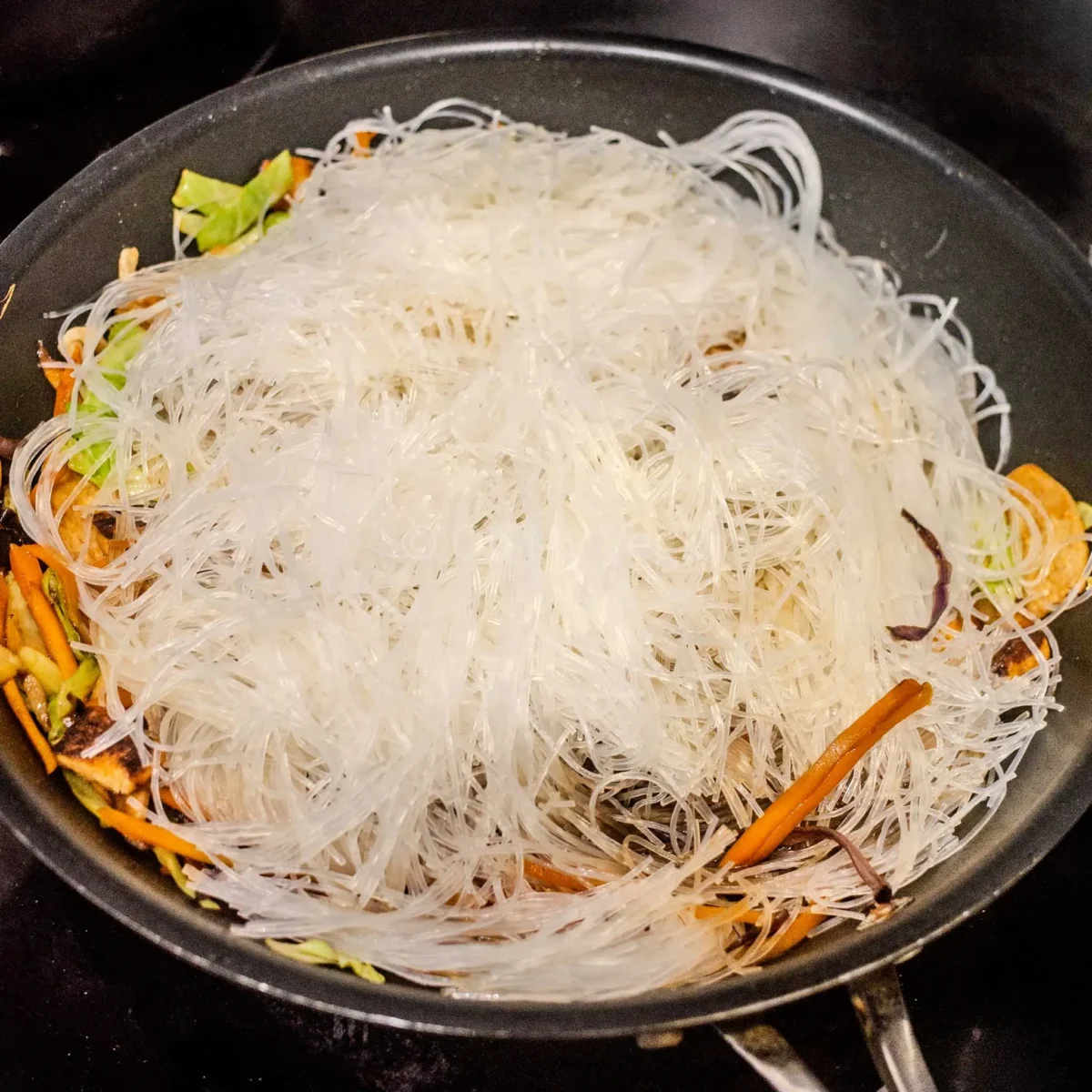 Glass noodles added to the pan.