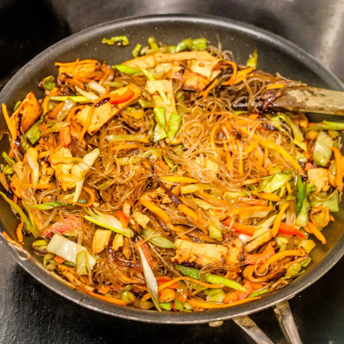 Glass noodle stir fry in pan.