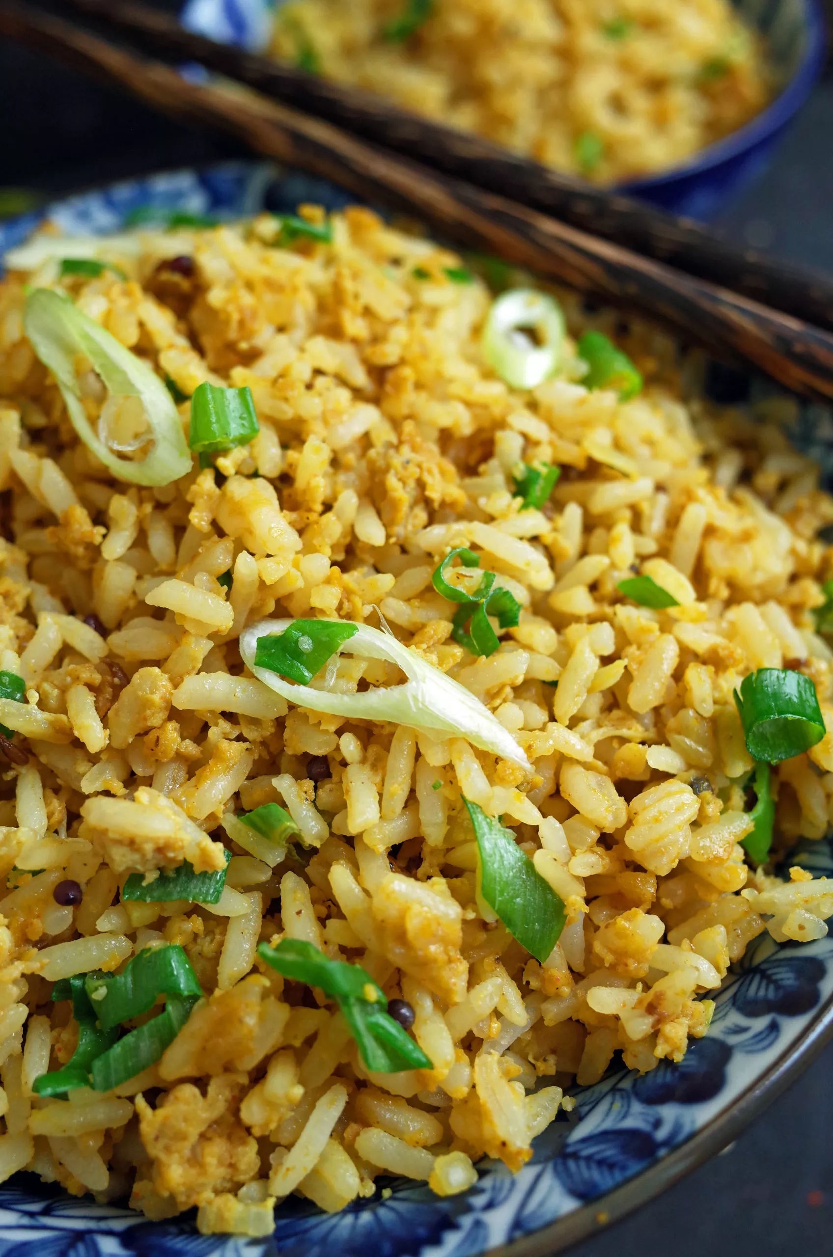 Indian Egg Fried Rice topped with Spring Onion in a blue bowl