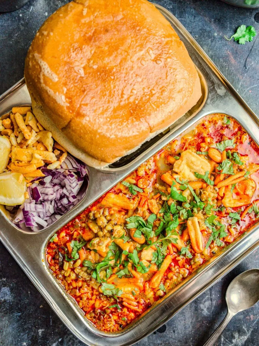 Maharashtrian Kolhapuri Misal pav on a steel plate.