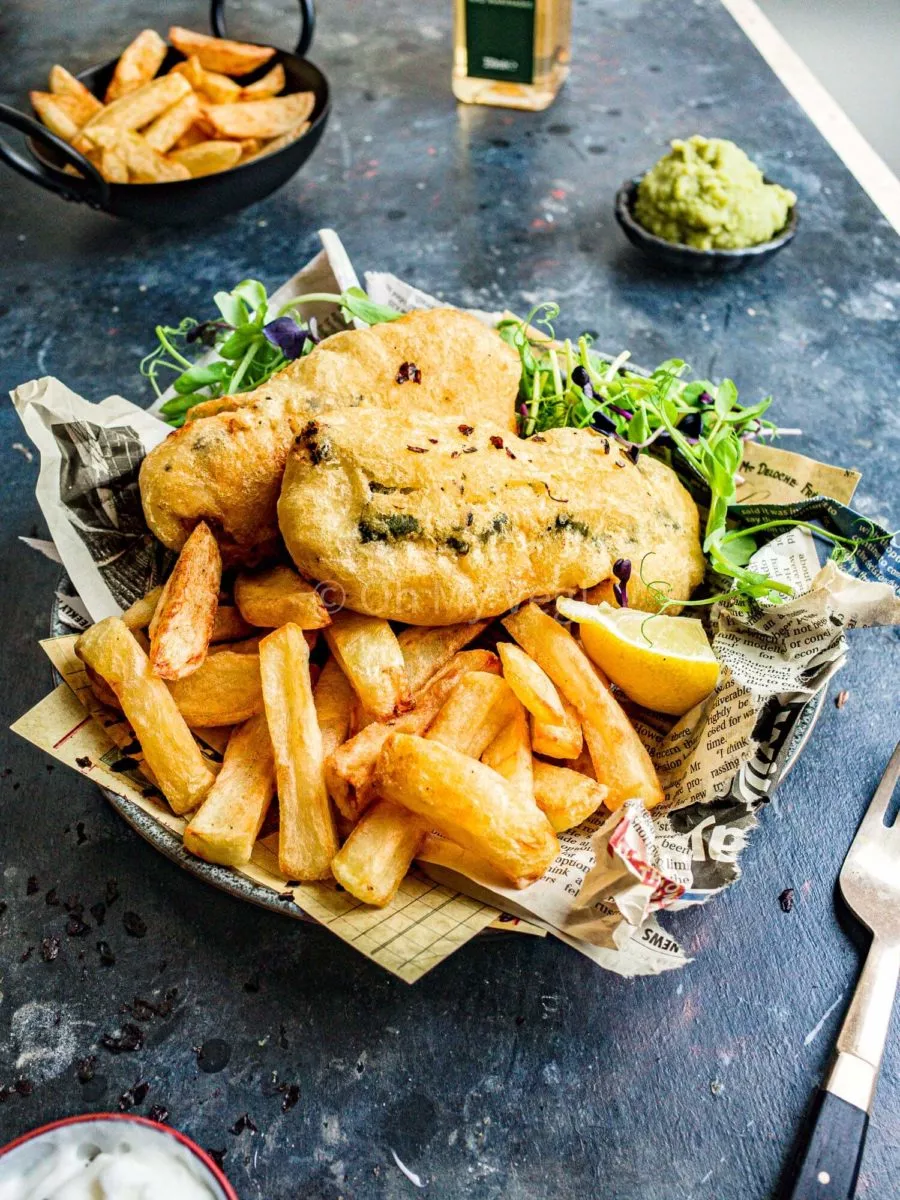 Vegan fish and chips with battered tofu, chips, and salad.