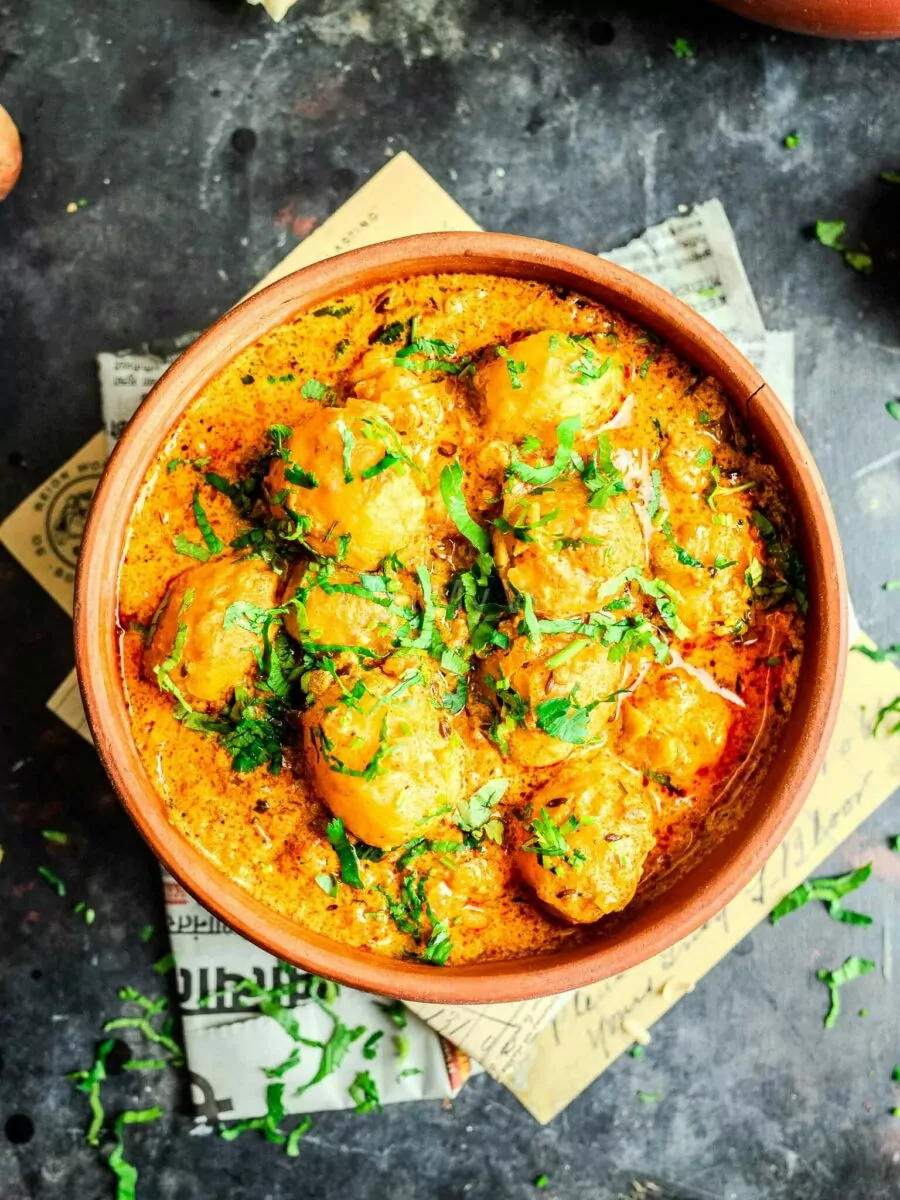 Spicy red dum aloo curry in a bowl.