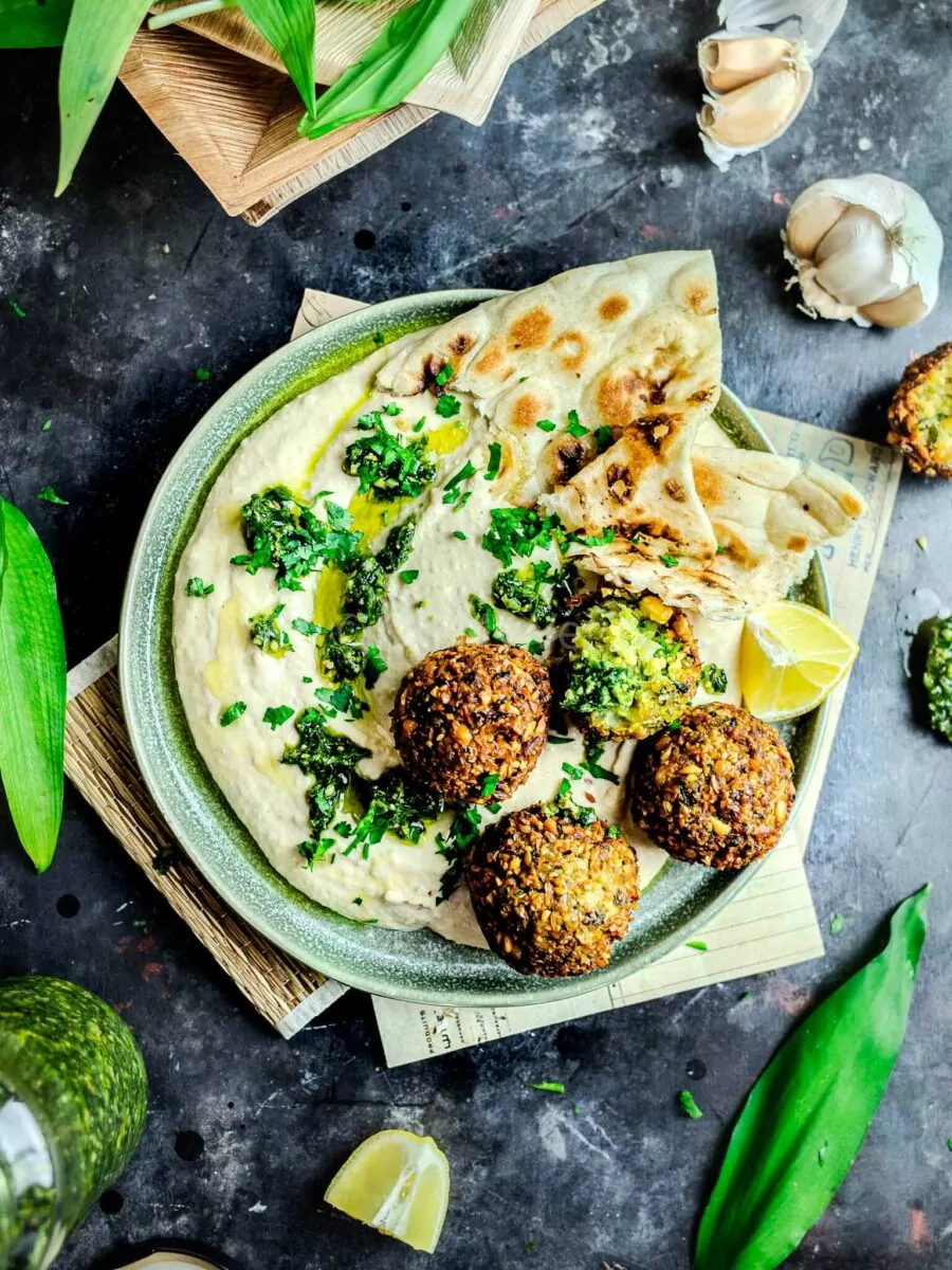 Wild garlic falafel on a bed of hummus with naan.