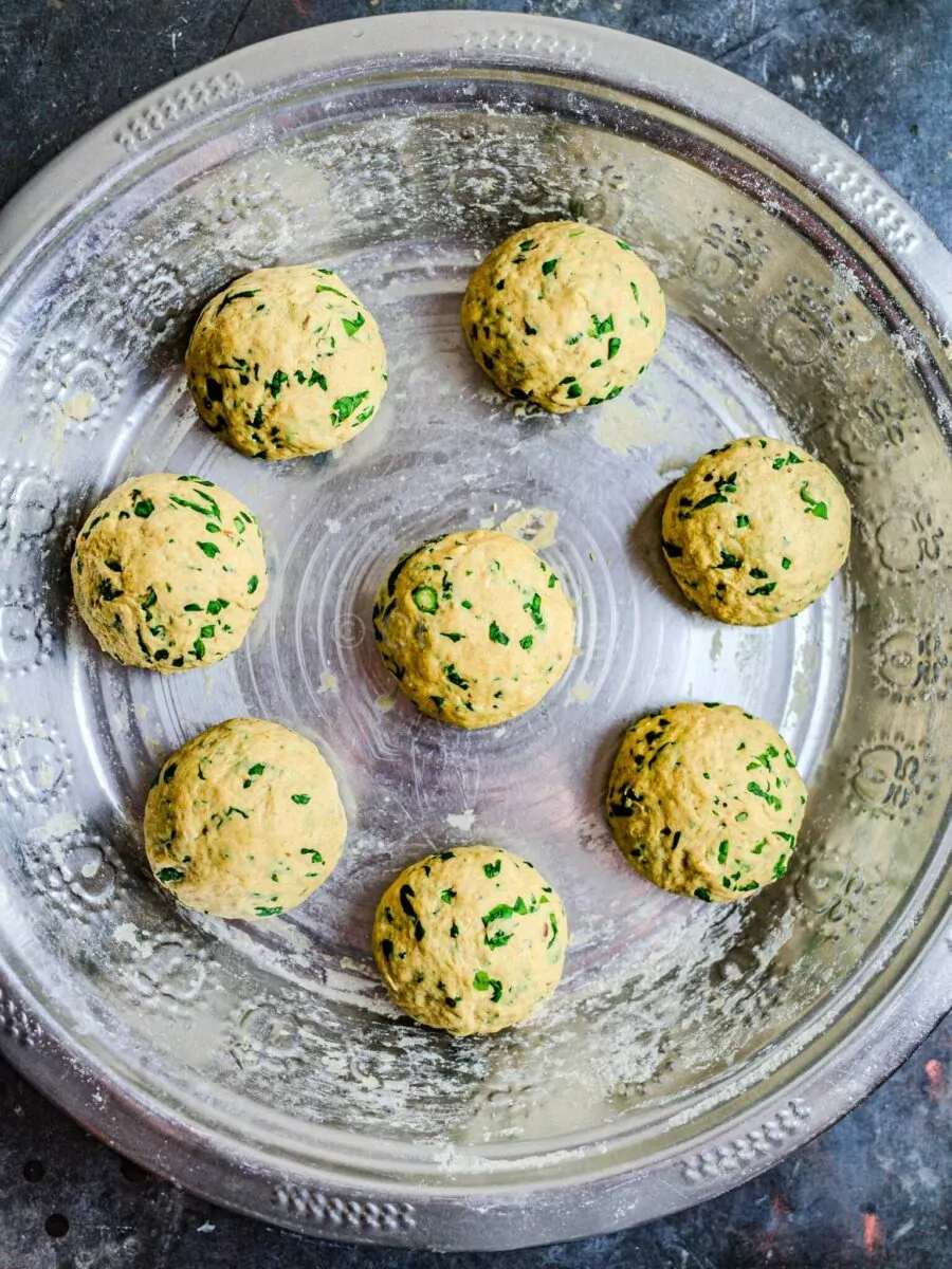 Methi paratha dough separated into balls.