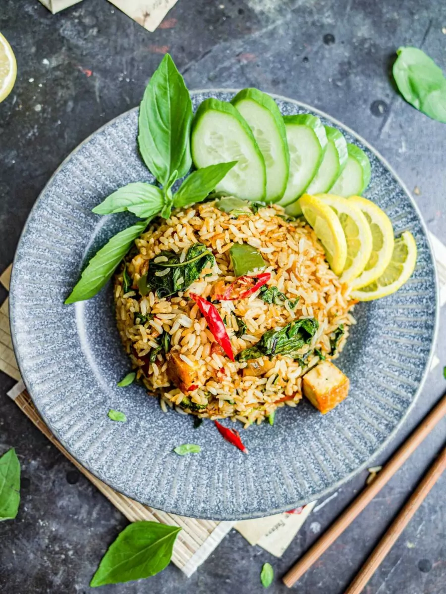 Thai basil fried rice with tofu on a gray plate.