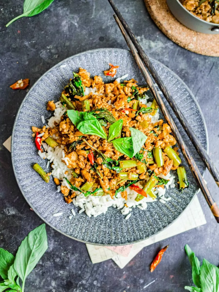 Vegan thai basil tofu stir fry with rice on a plate.