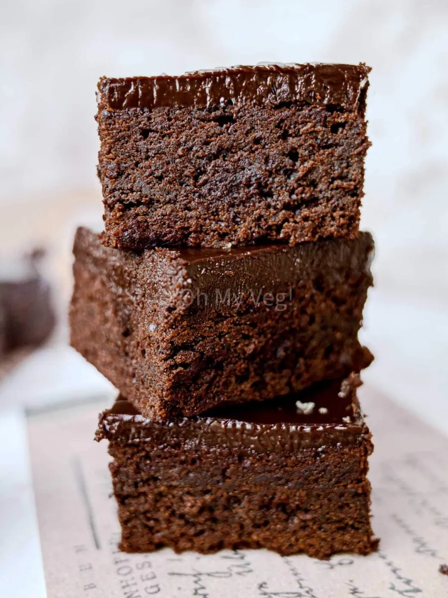A stack of three chocolate brownies. 