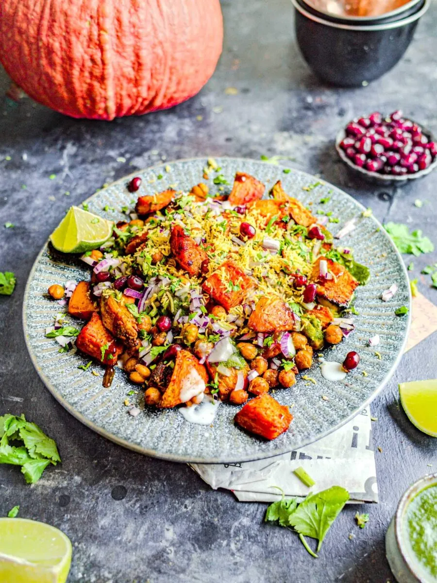 Sweet potato chaat on a dark blue surface.