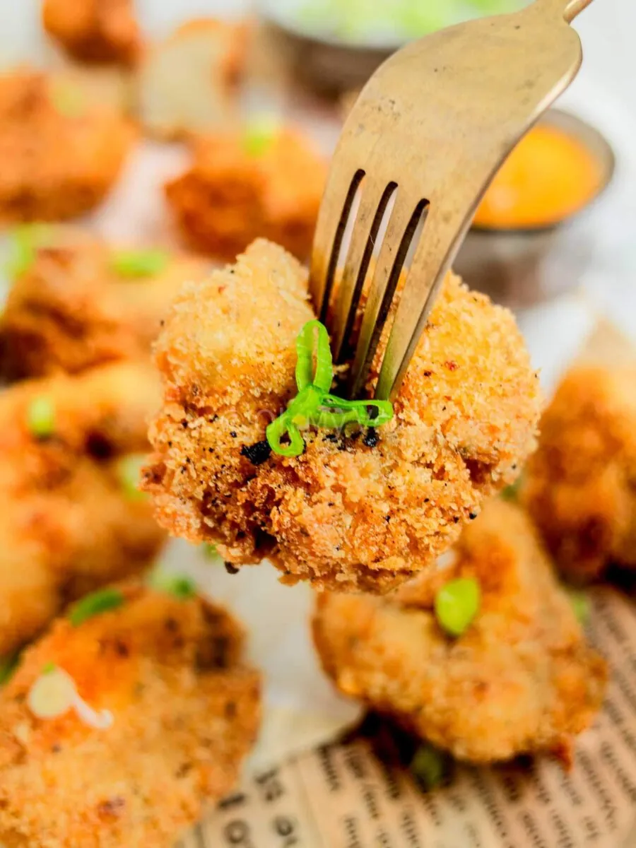 Fork piercing a cauliflower nugget.