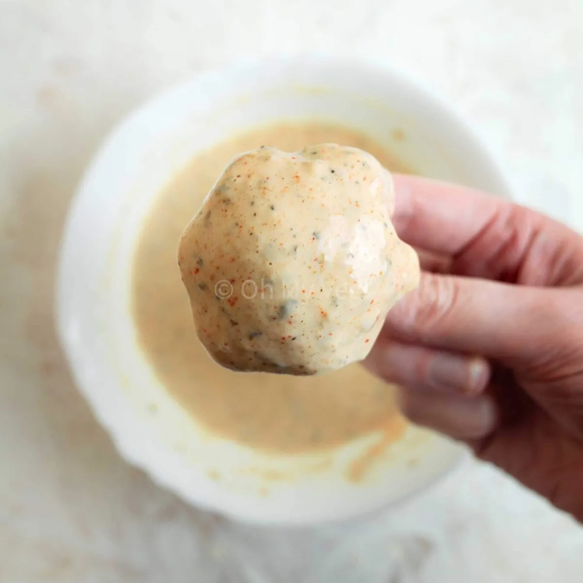 Battering cauliflower nuggets.