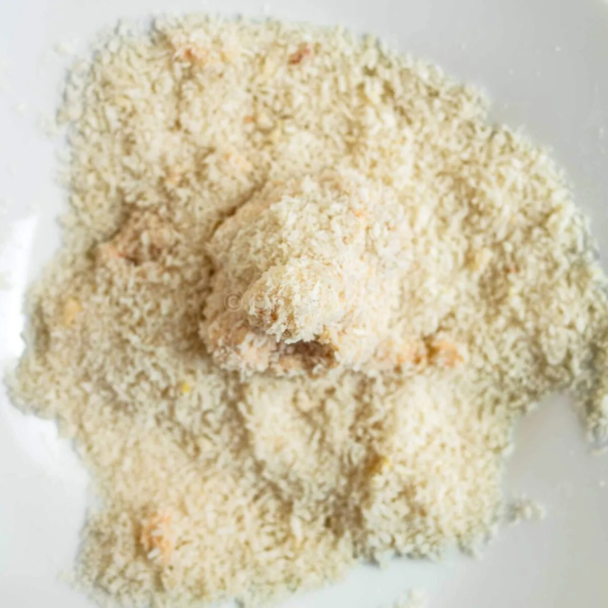 Breading cauliflower nuggets.