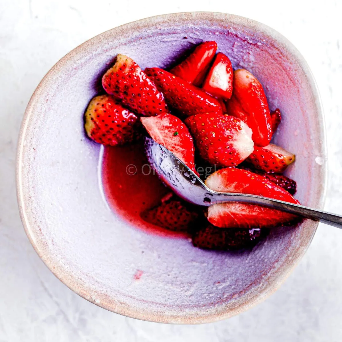 Macerated strawberries in a bowl.
