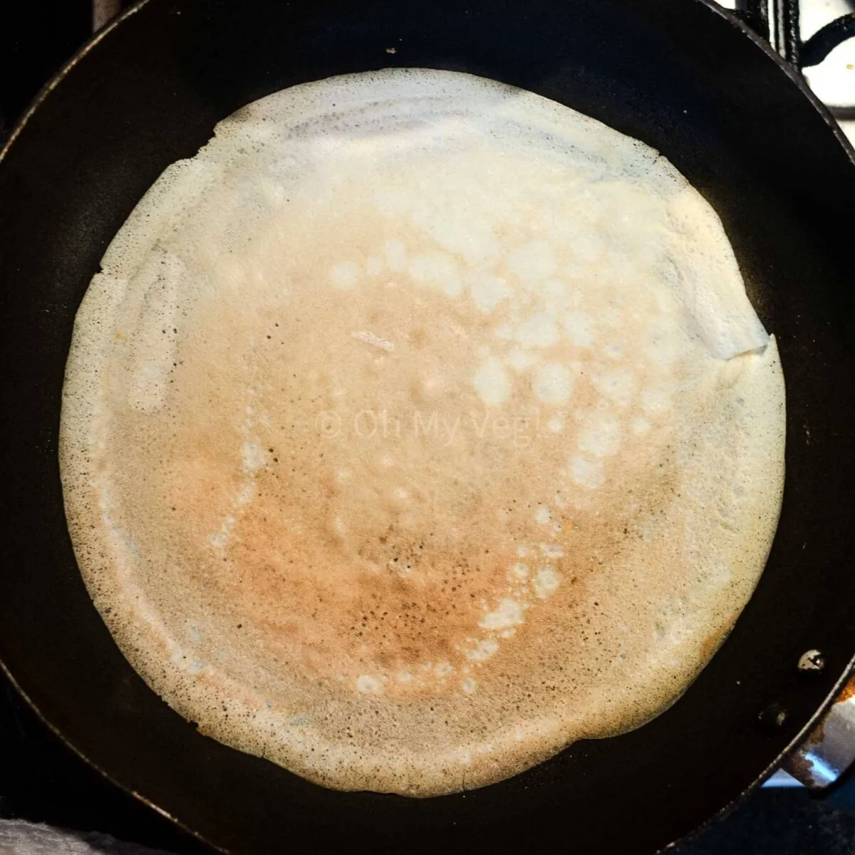 Slightly browned crepe in a pan.