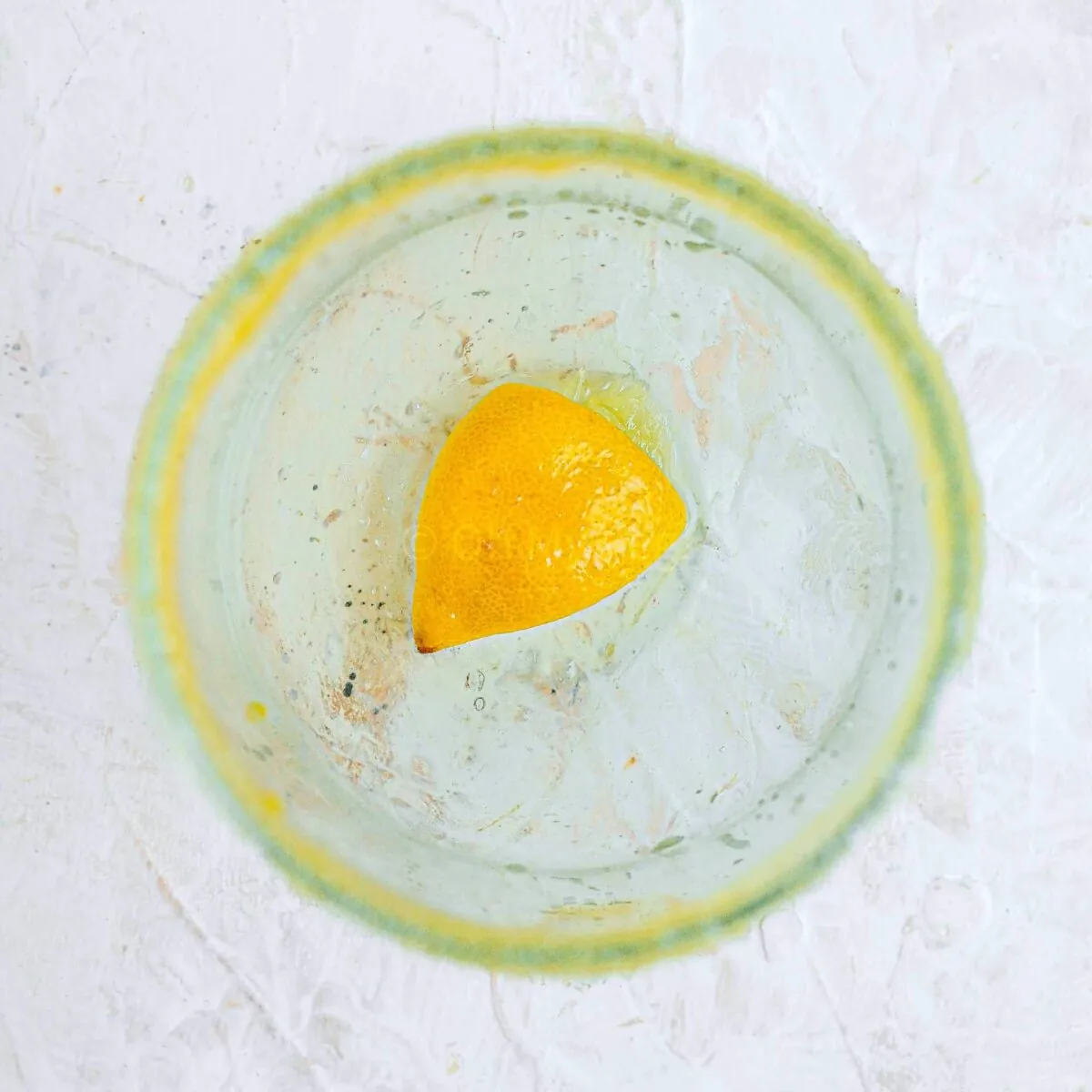 Muddled lemon in a glass.