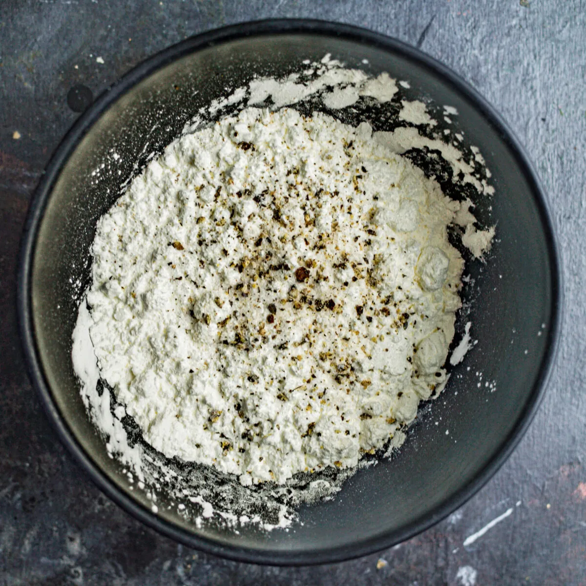 Seasoned flour in a bowl.