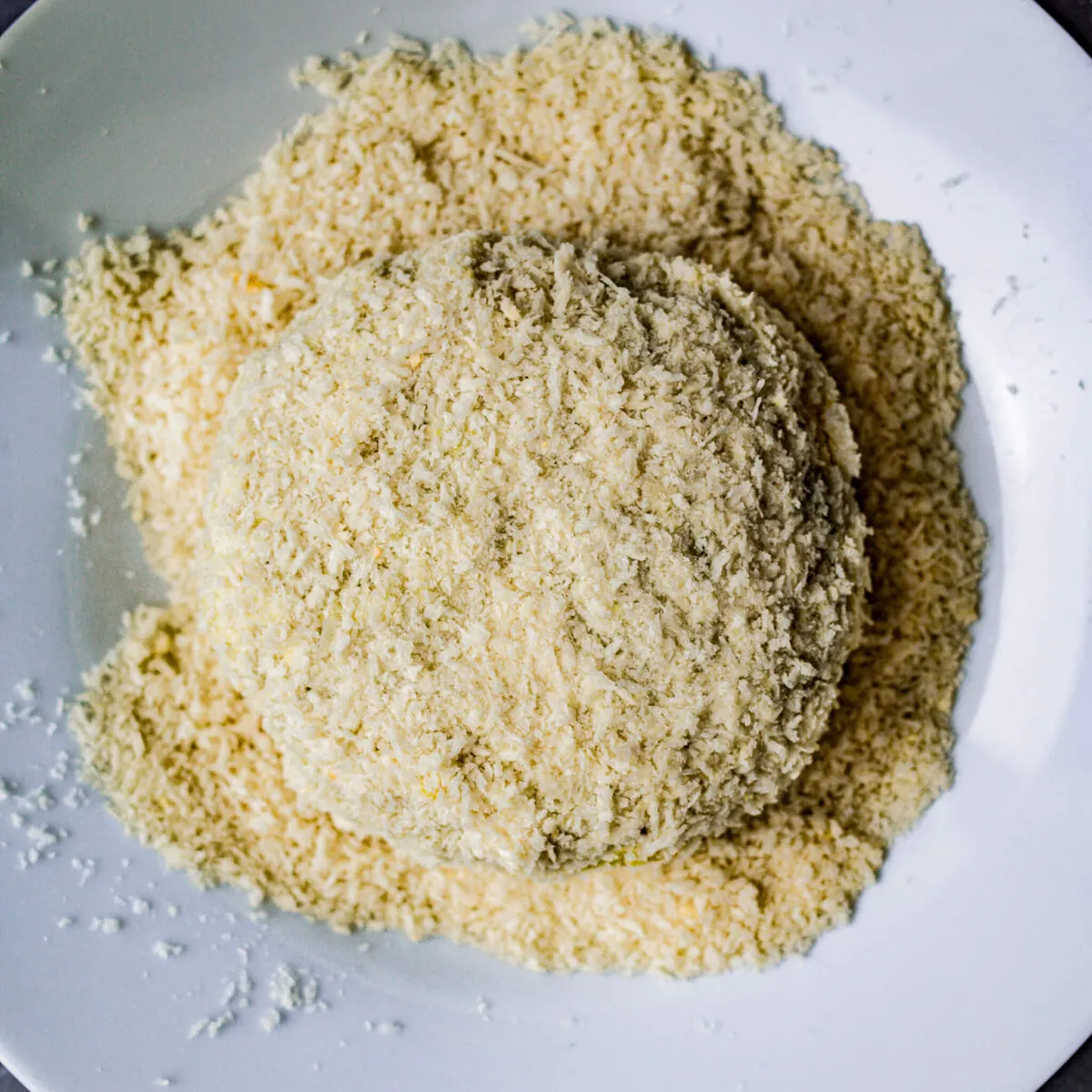 Aloo tikki coated in breadcrumbs.
