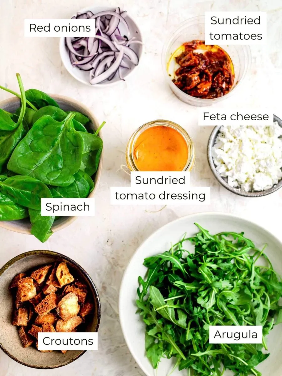 Ingredients for spinach and arugula salad, with text labels.