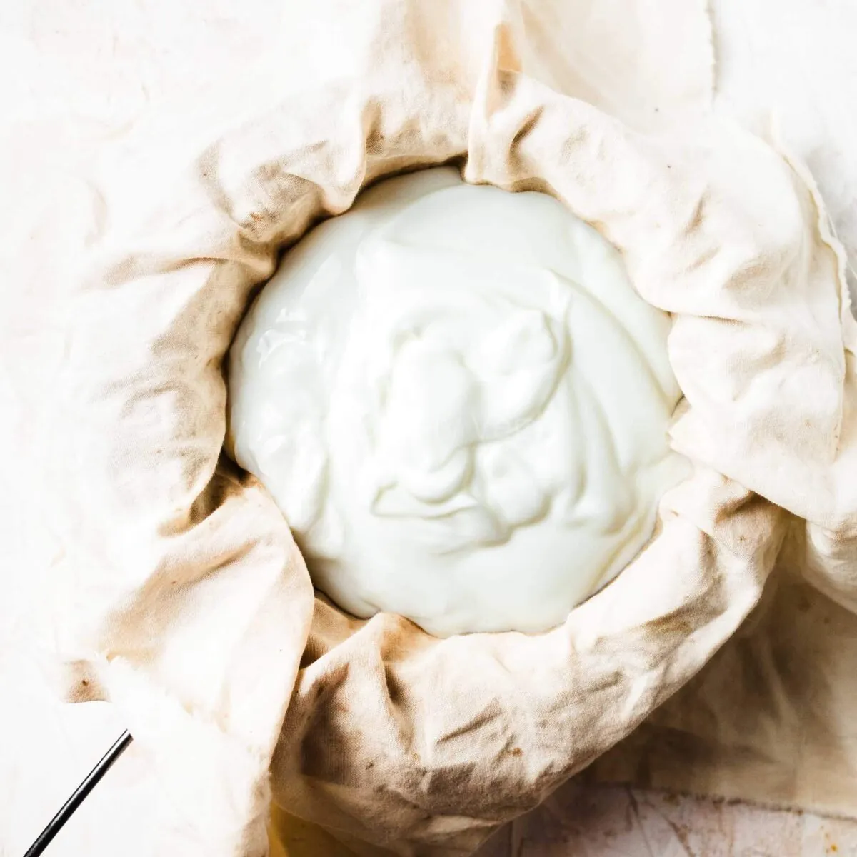 Greek yoghurt in a cheesecloth.